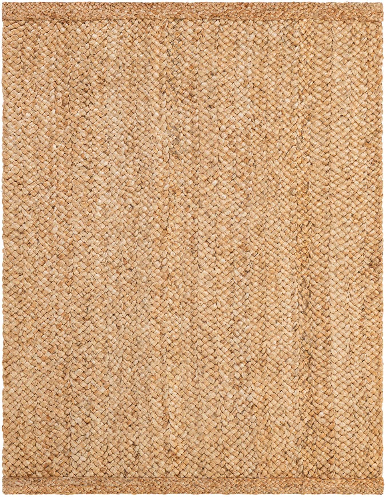 A 4x6 rectangular Heirloom Braided Jute rug in natural brown and tan tones, featuring a tight, textured weave.