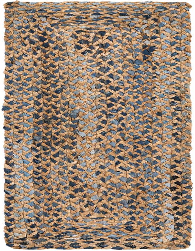 A close-up of a braided table runner rug made from natural jute and blue denim strips, showcasing its textured, eco-friendly design.