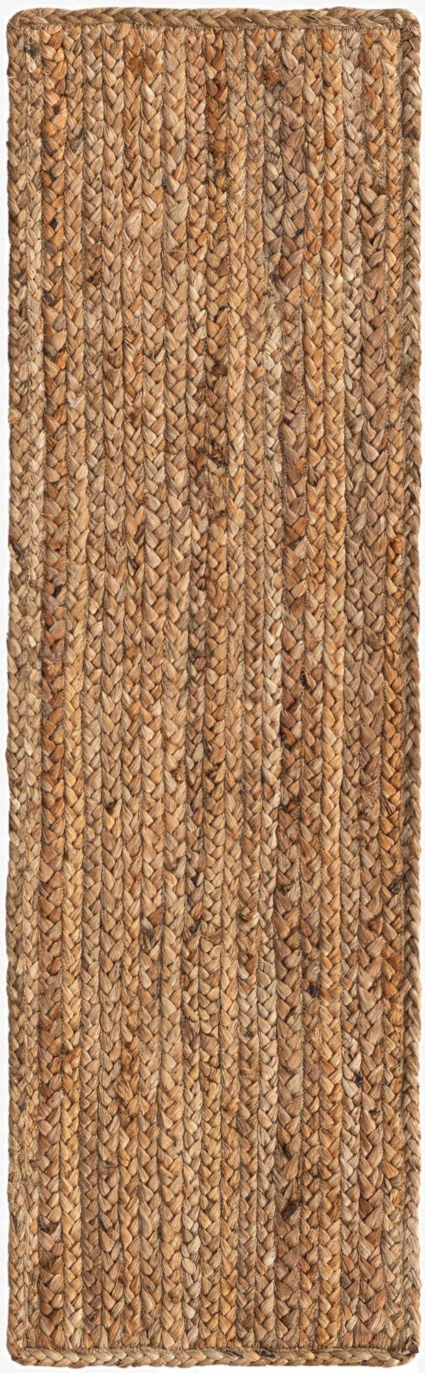 A close-up view of a 1' 2 x 4' 1 Braided Jute table runner rug, showcasing its natural brown and tan woven texture.