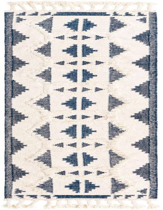 A 13 ft runner rug with a tribal pattern in navy blue and off-white, featuring shag texture and tassels.