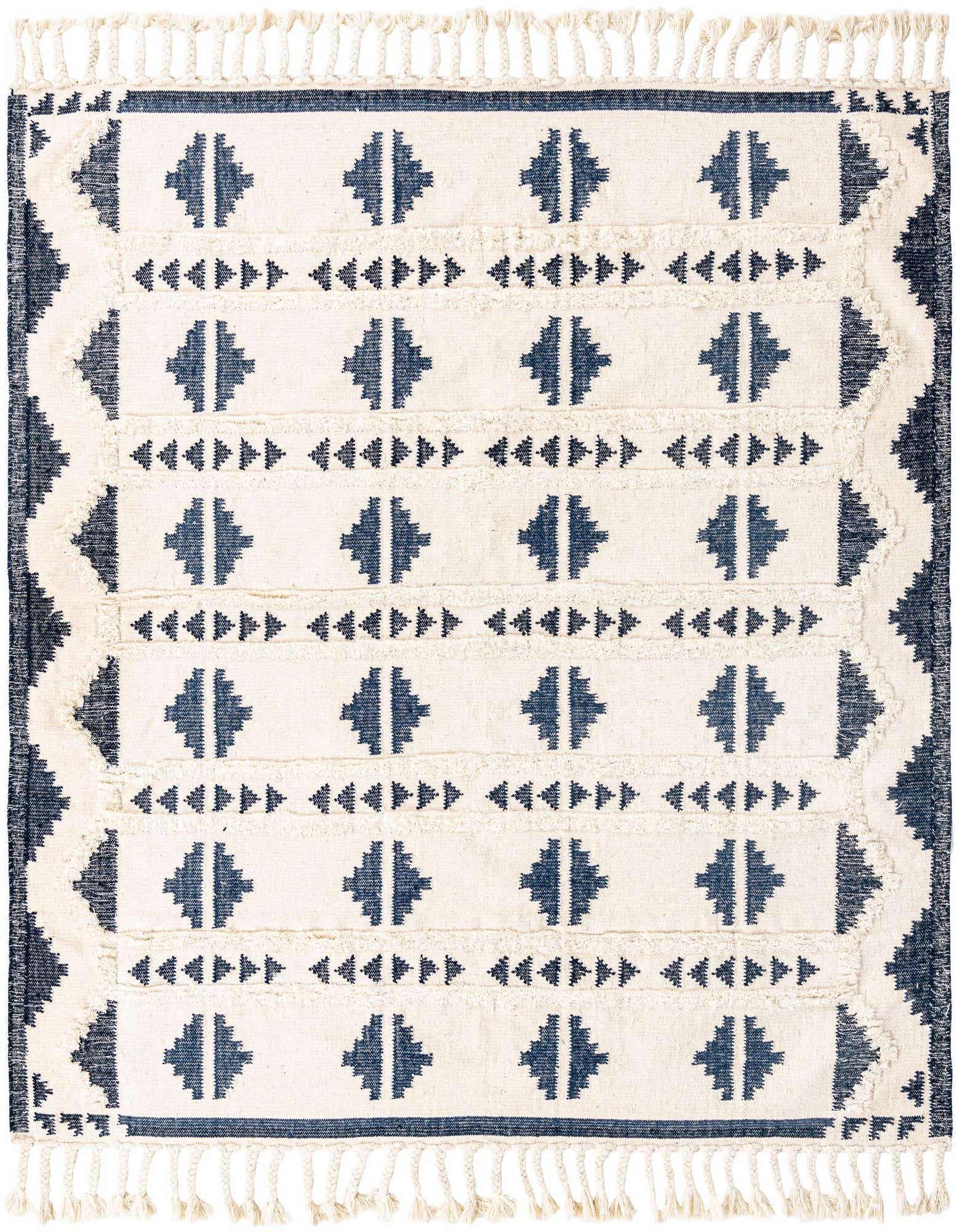 A square 8' x 8' Rugs.com Arizona rug featuring a tribal pattern in navy blue and off-white, with shag texture and fringe.