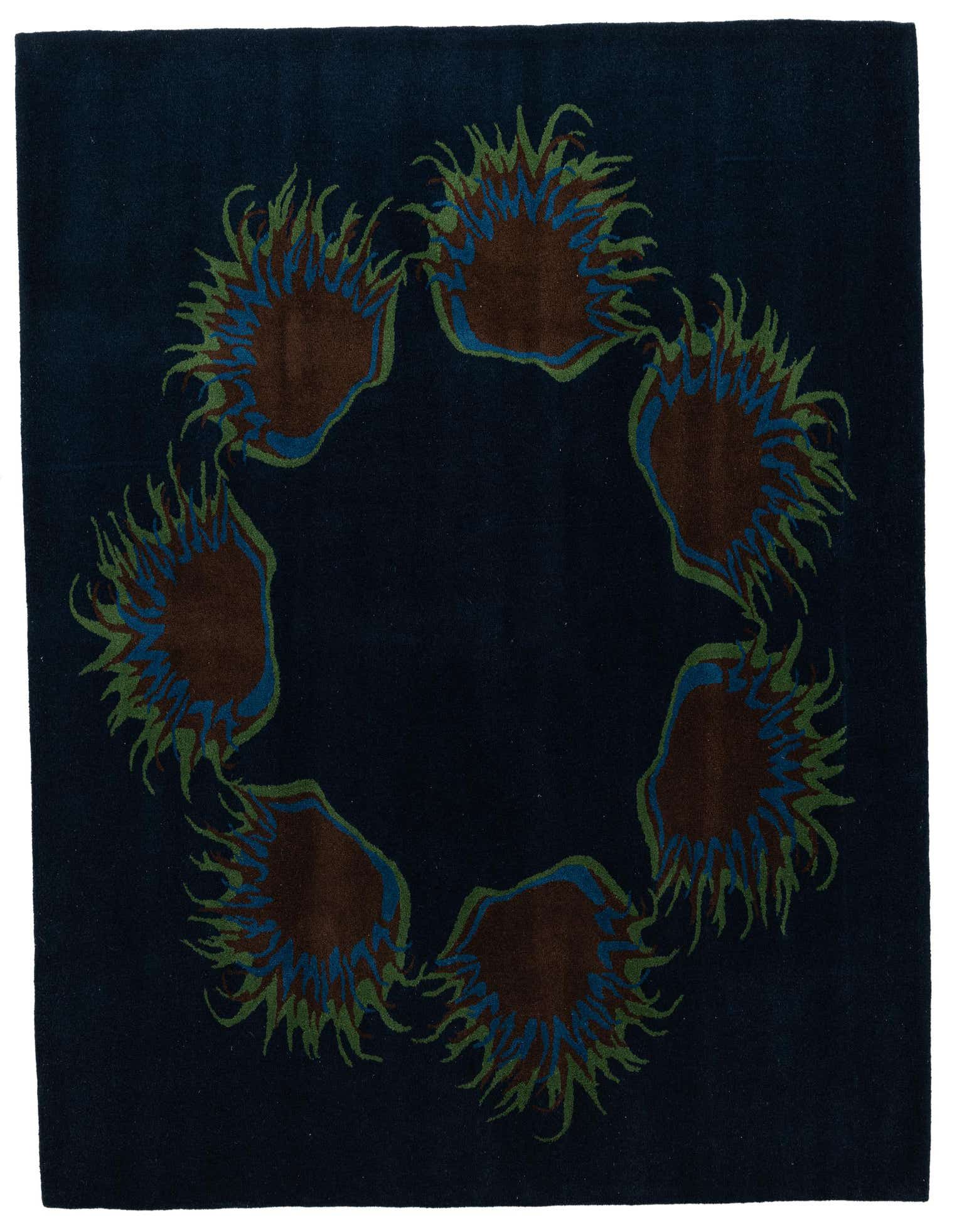 A 6x9 rectangular navy blue rug with a circular traditional pattern of brown, green, and blue floral motifs.