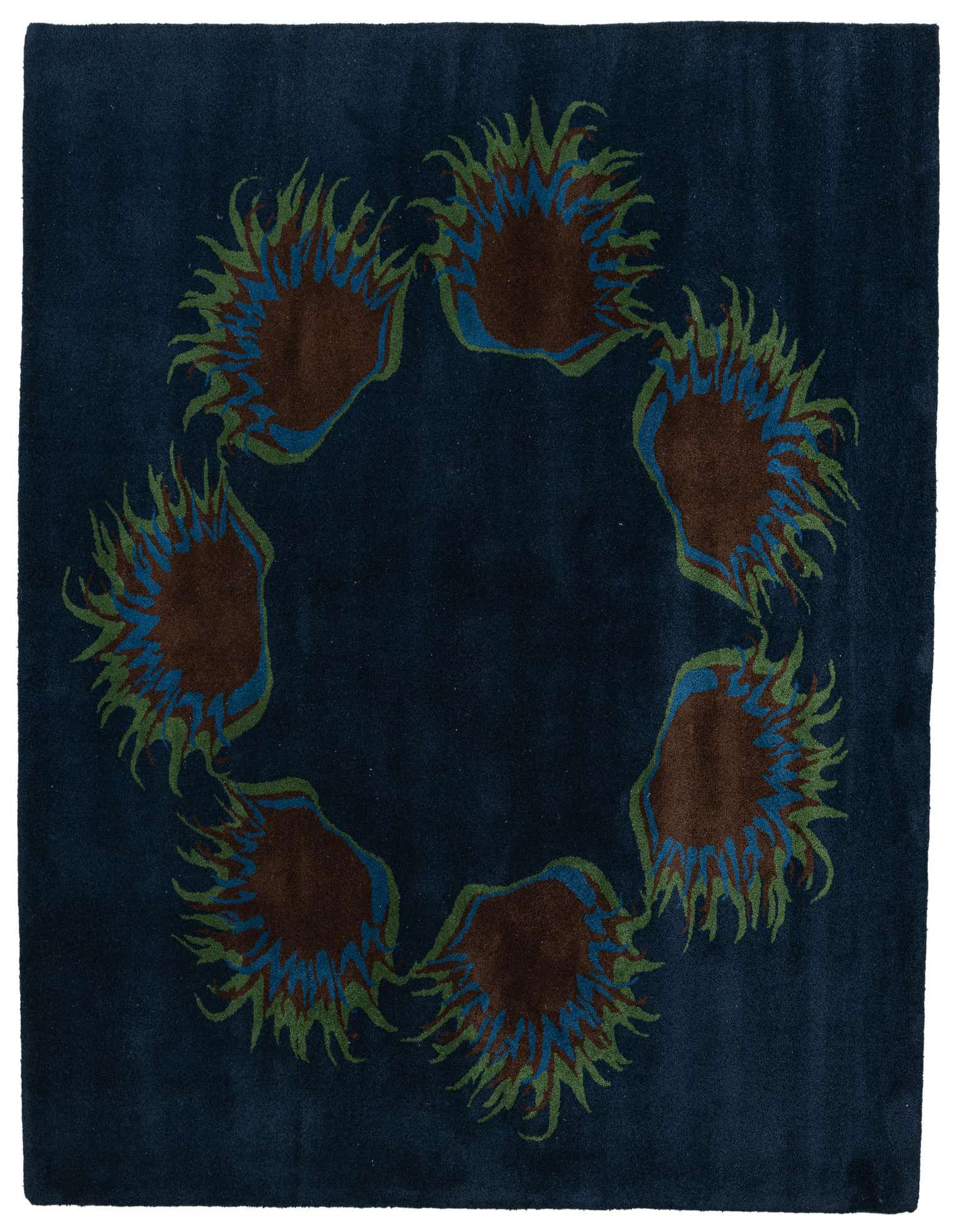A 6x9 rectangular navy blue wool rug featuring a circular traditional pattern of brown, blue, and green floral motifs.