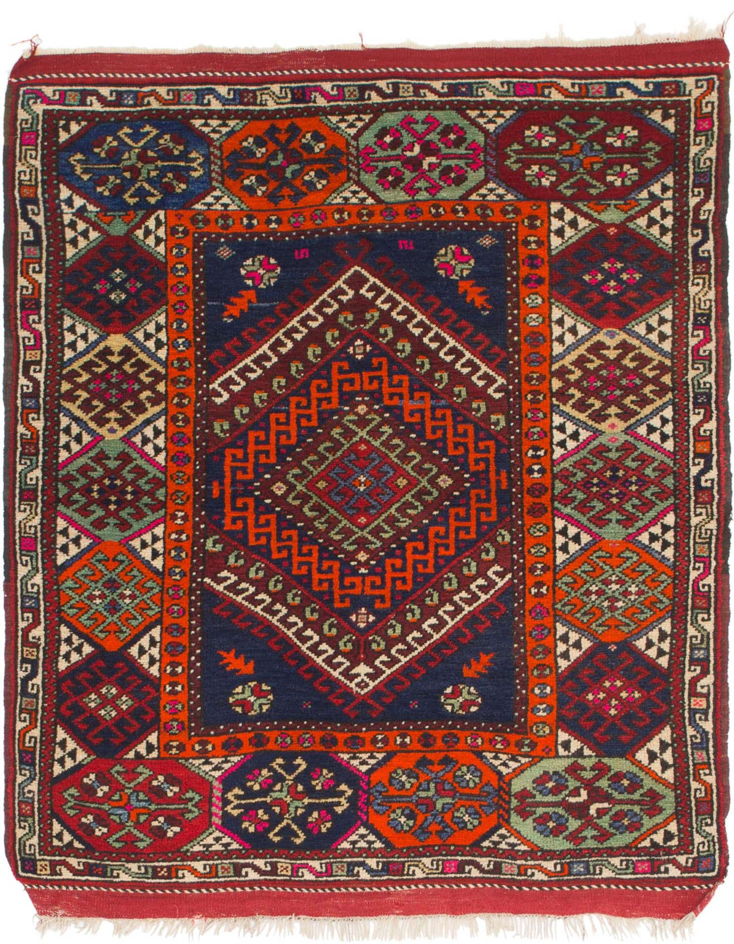 A 4x6 rectangular Anatolian wool rug featuring a central navy blue medallion with intricate orange, red, and green traditional patterns, surrounded by a multi-colored border.