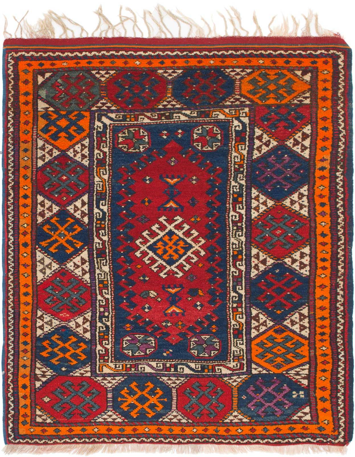 A 4x6 rectangular Anatolian wool rug featuring a traditional Southwestern tribal pattern in deep blues, reds, oranges, and cream, with a central medallion and fringe.