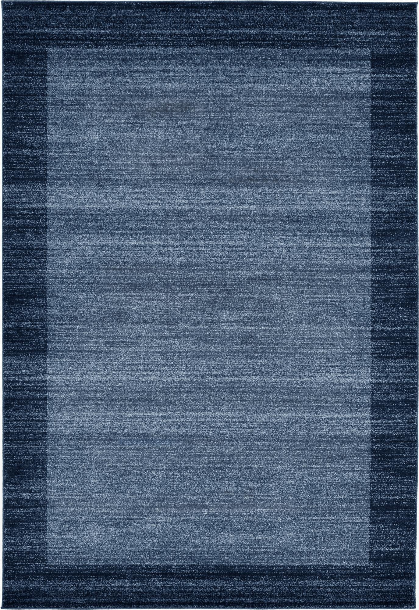 A 6x9 rectangular Angelica rug in varying shades of blue, featuring a solid contemporary design with a darker blue border.