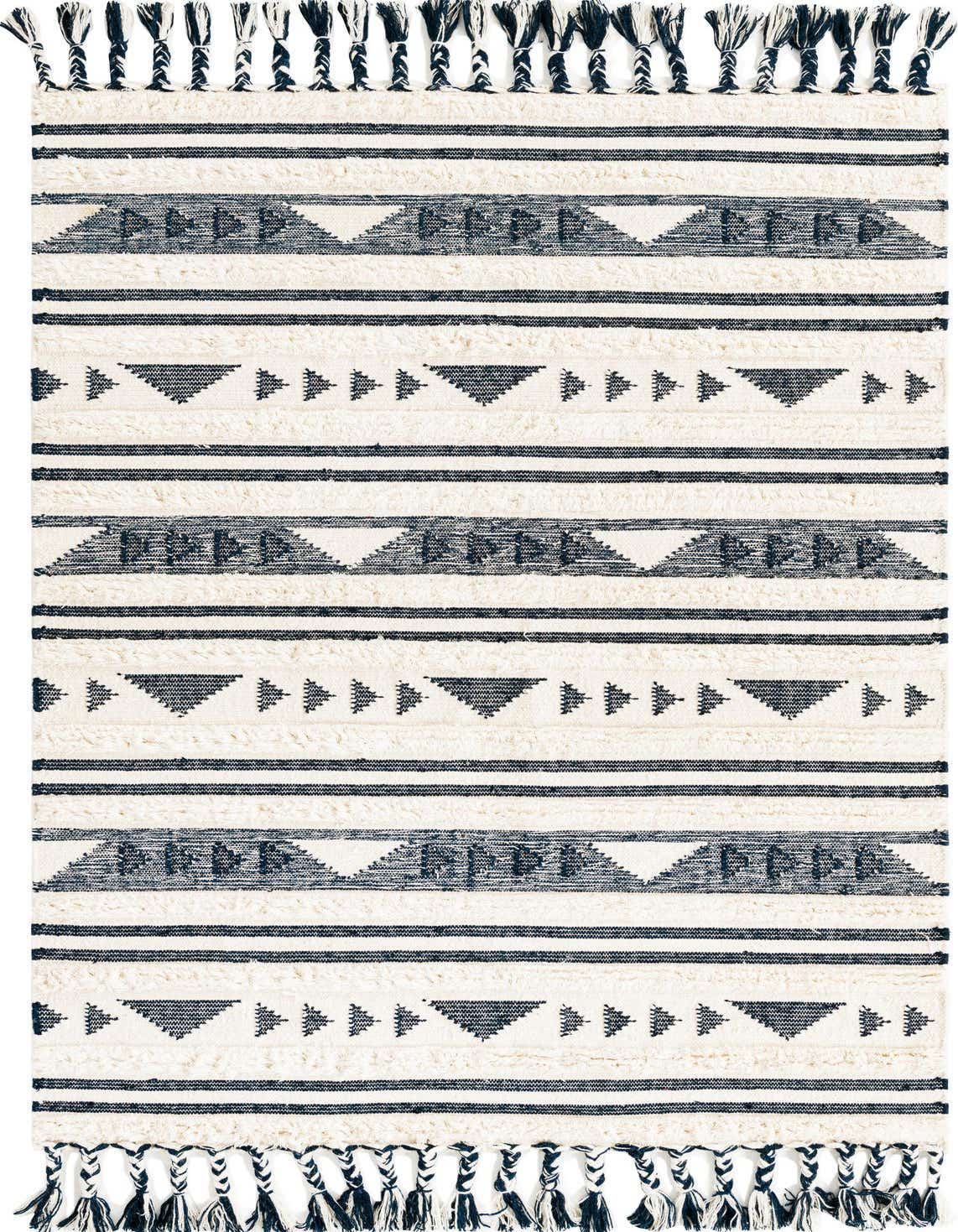 A 5x8 rectangular Rugs.com Arizona rug featuring a navy blue tribal and stripe pattern on a cream shag background, with braided tassels.