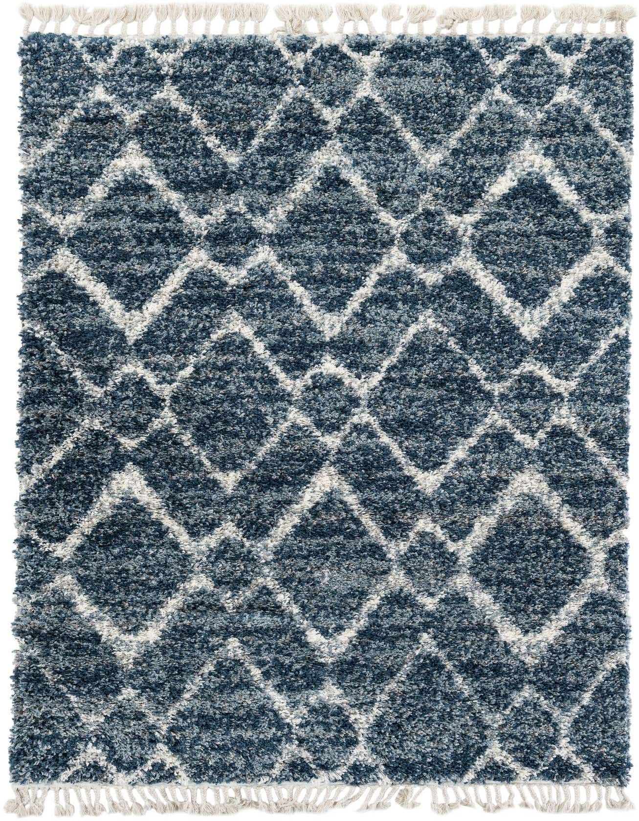 A rectangular 5x8 Athena Shag rug in varying shades of blue with a modern geometric diamond pattern in white, featuring white tassels on the ends.