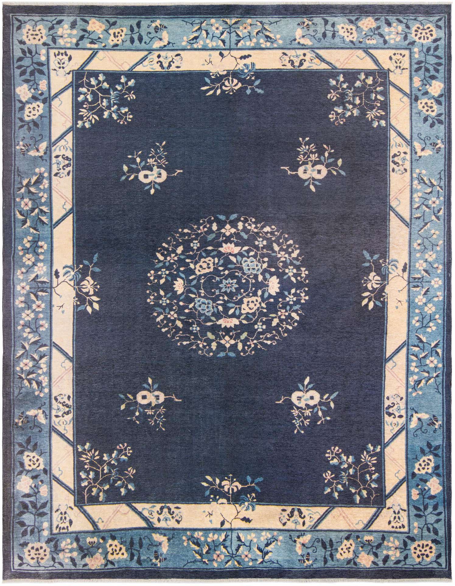 A 9x12 rectangular navy blue rug with a light blue and cream border, featuring a central floral medallion and scattered floral motifs.