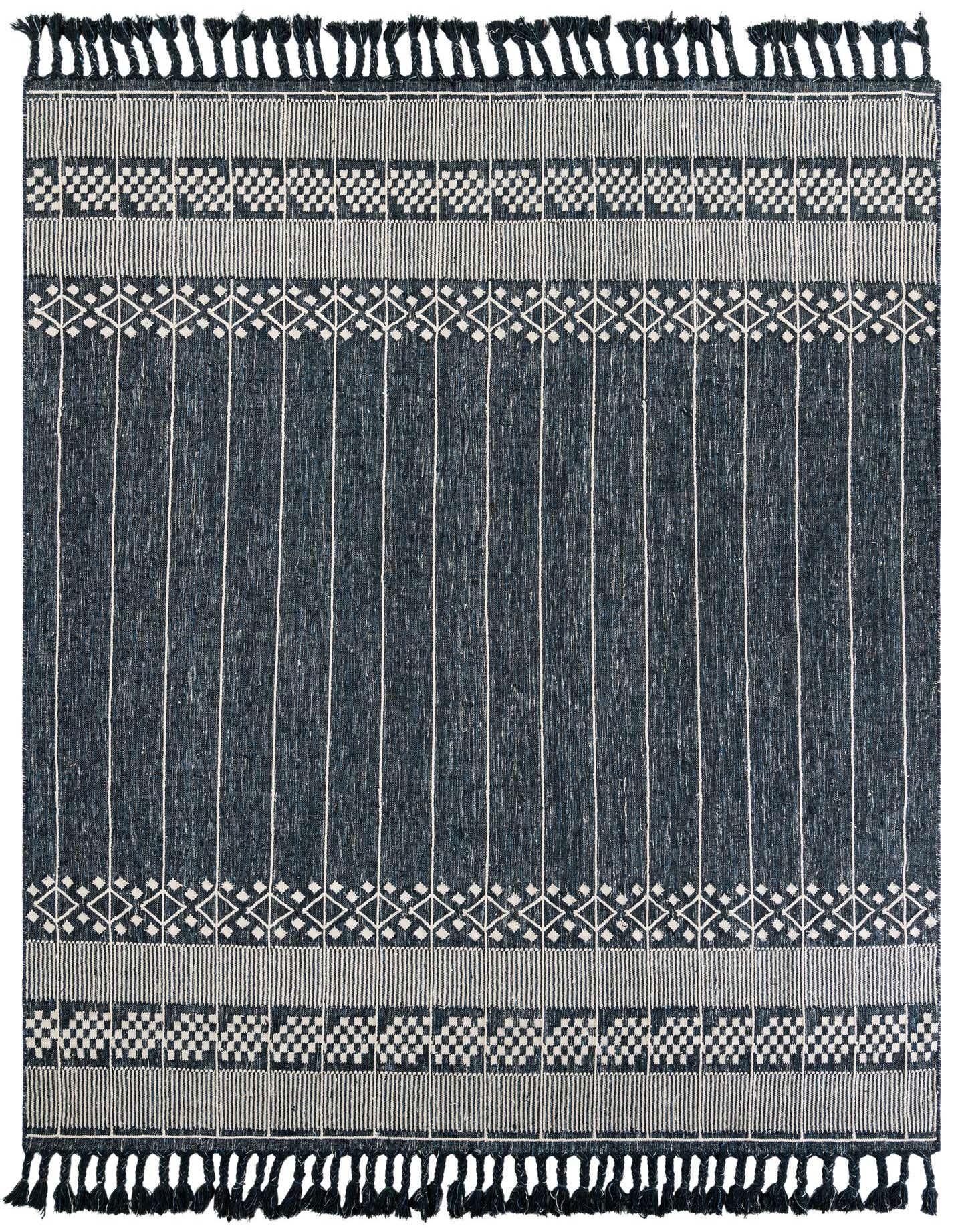 A 9x12 rectangular Eco Bohemian rug in navy blue with white modern striped and geometric patterns, featuring tassels.