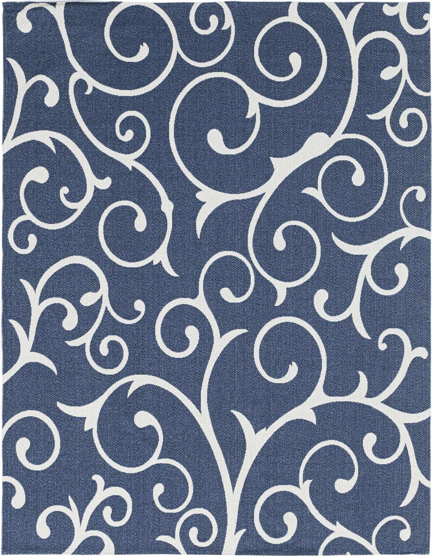 A close-up of an 8x11 rectangular navy blue flatweave rug with a white traditional floral scroll pattern.