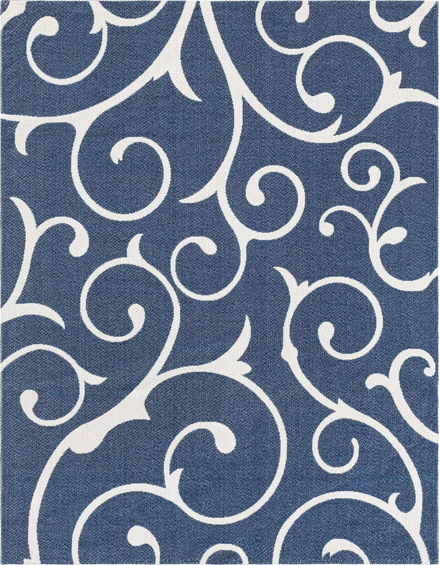 A 6x9 rectangular navy blue flatweave rug with a repeating white floral scroll pattern, suitable for a living room.