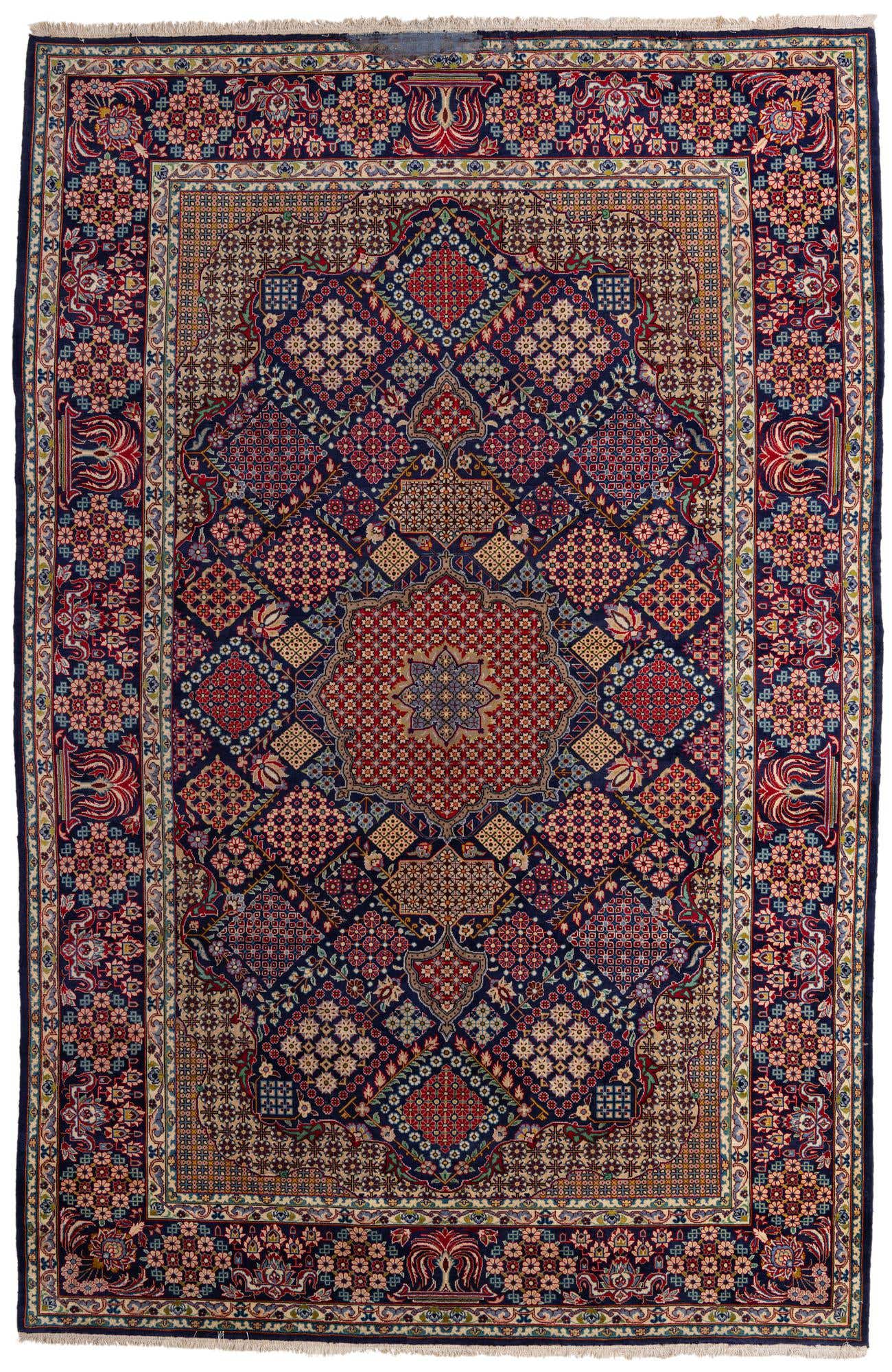 A large 10x14 rectangular Isfahan rug featuring a complex traditional Persian medallion and botanical pattern in deep blues, reds, and creams.