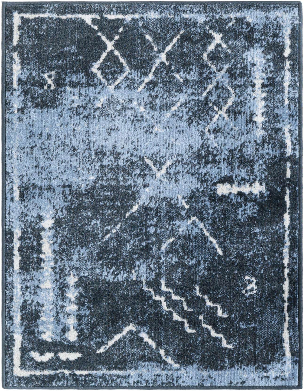 A 2x3 rectangular Kamala Washable rug featuring a distressed vintage tribal pattern in shades of navy and light blue.