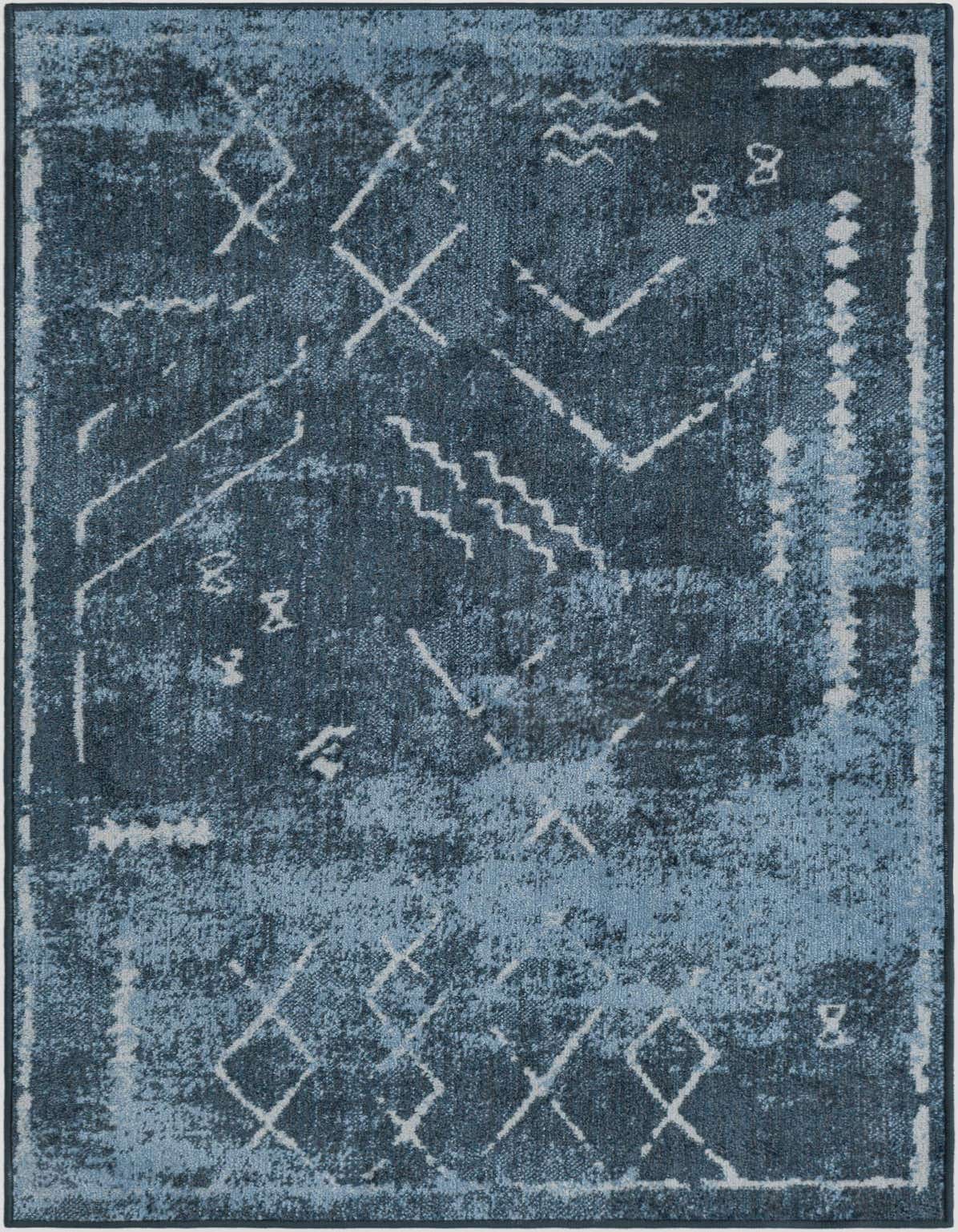 A 3x5 rectangular Kamala Washable rug featuring a distressed vintage tribal pattern in varying shades of blue, ideal for an indoor space.