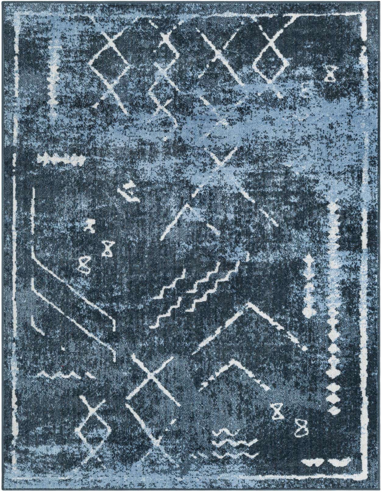 A 4x6 rectangular Kamala Washable rug featuring a distressed vintage tribal pattern in shades of navy and light blue with white accents.