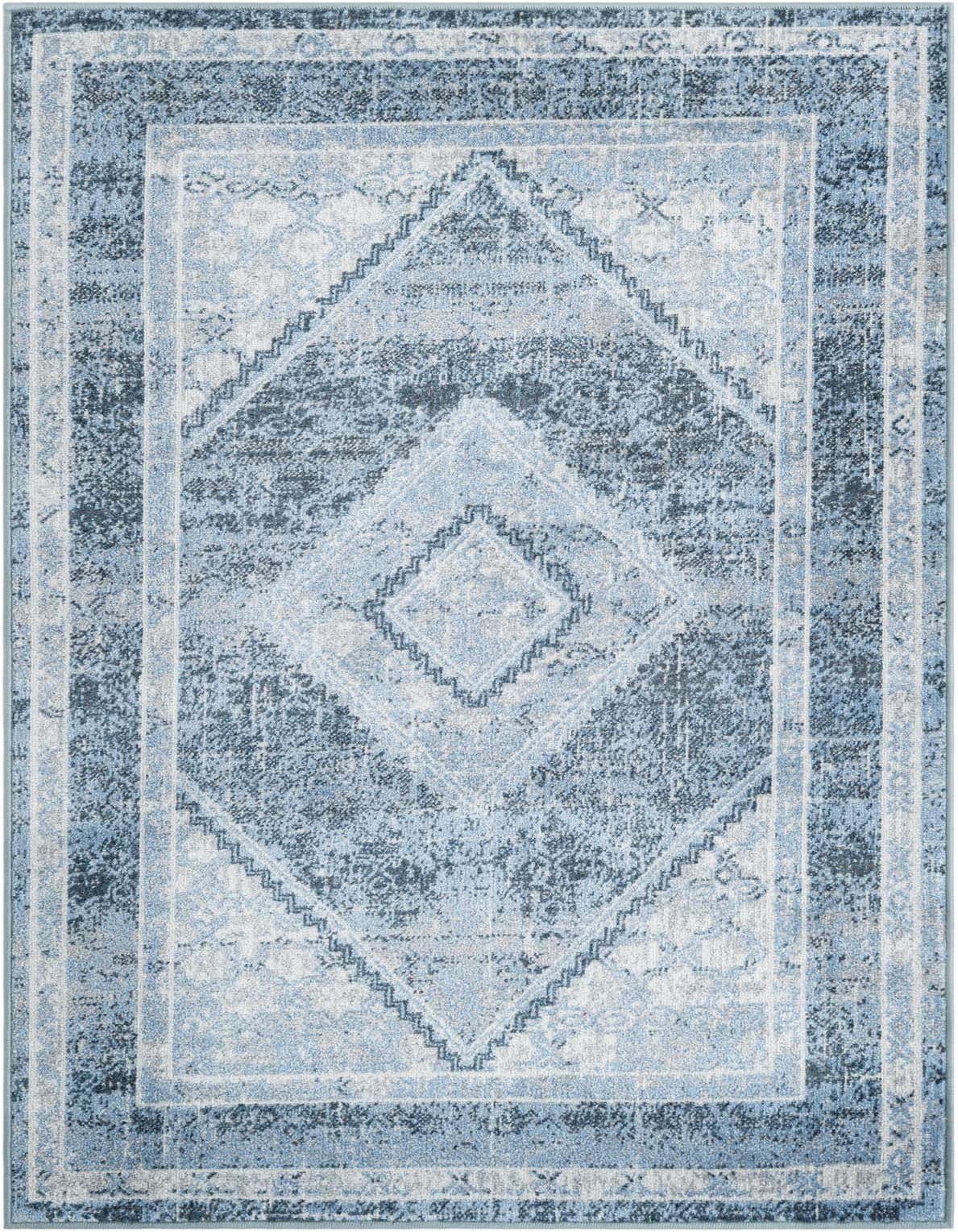 A 3x5 rectangular Kamala Washable rug featuring a distressed traditional medallion pattern in varying shades of blue and white.