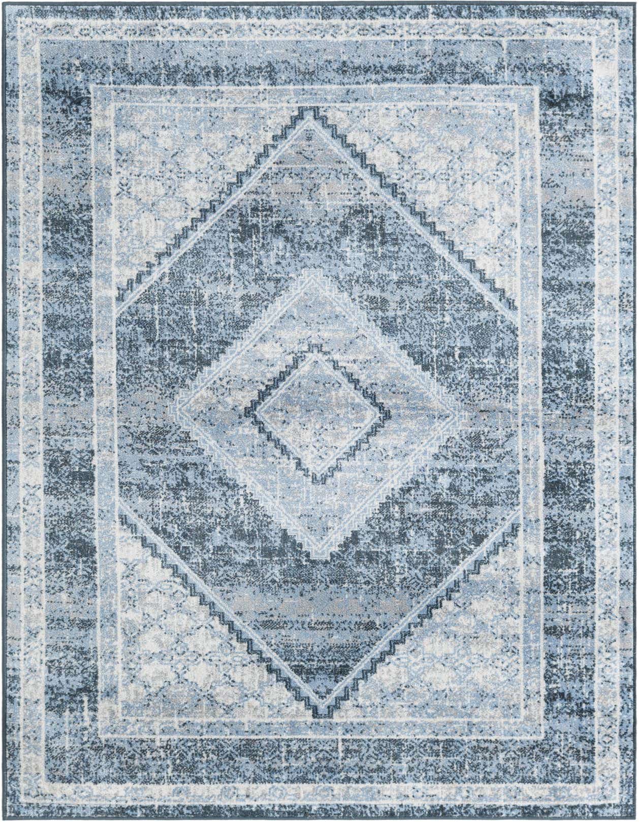 A 4x6 rectangular Kamala Washable rug featuring a distressed traditional medallion pattern in varying shades of blue, gray, and white.