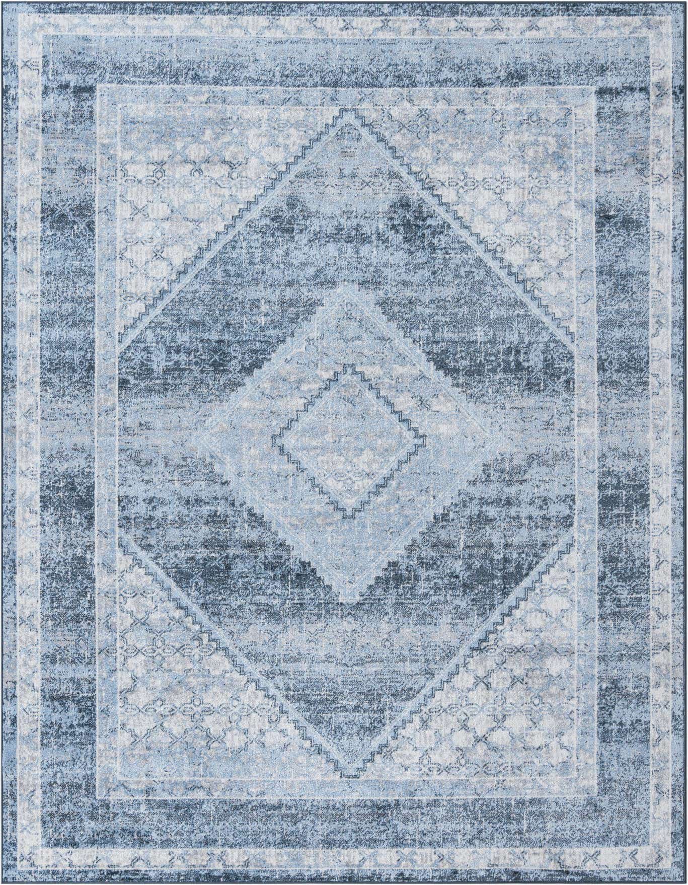 A 6x9 rectangular Kamala Washable rug featuring a distressed traditional medallion pattern in varying shades of blue, ideal for a living room.