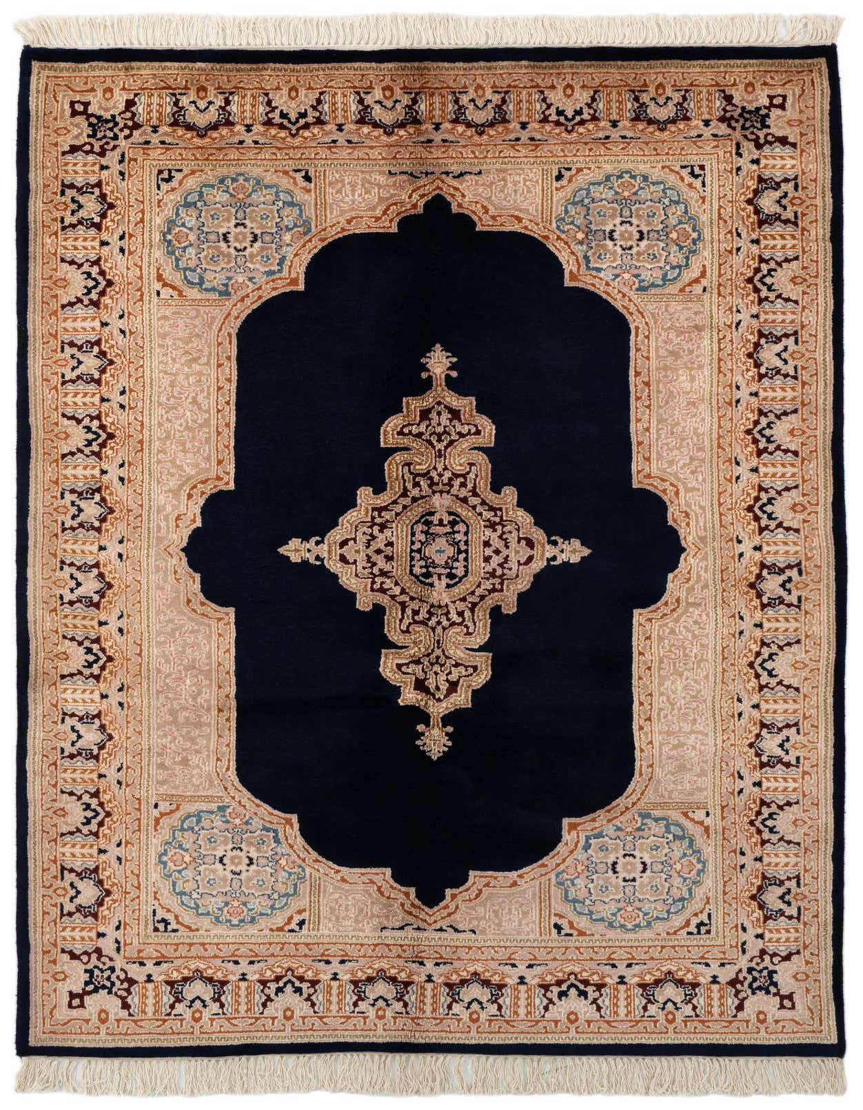 A 4x6 rectangular Kerman rug in traditional Oriental style, featuring a navy blue field with an intricate medallion and a beige border.