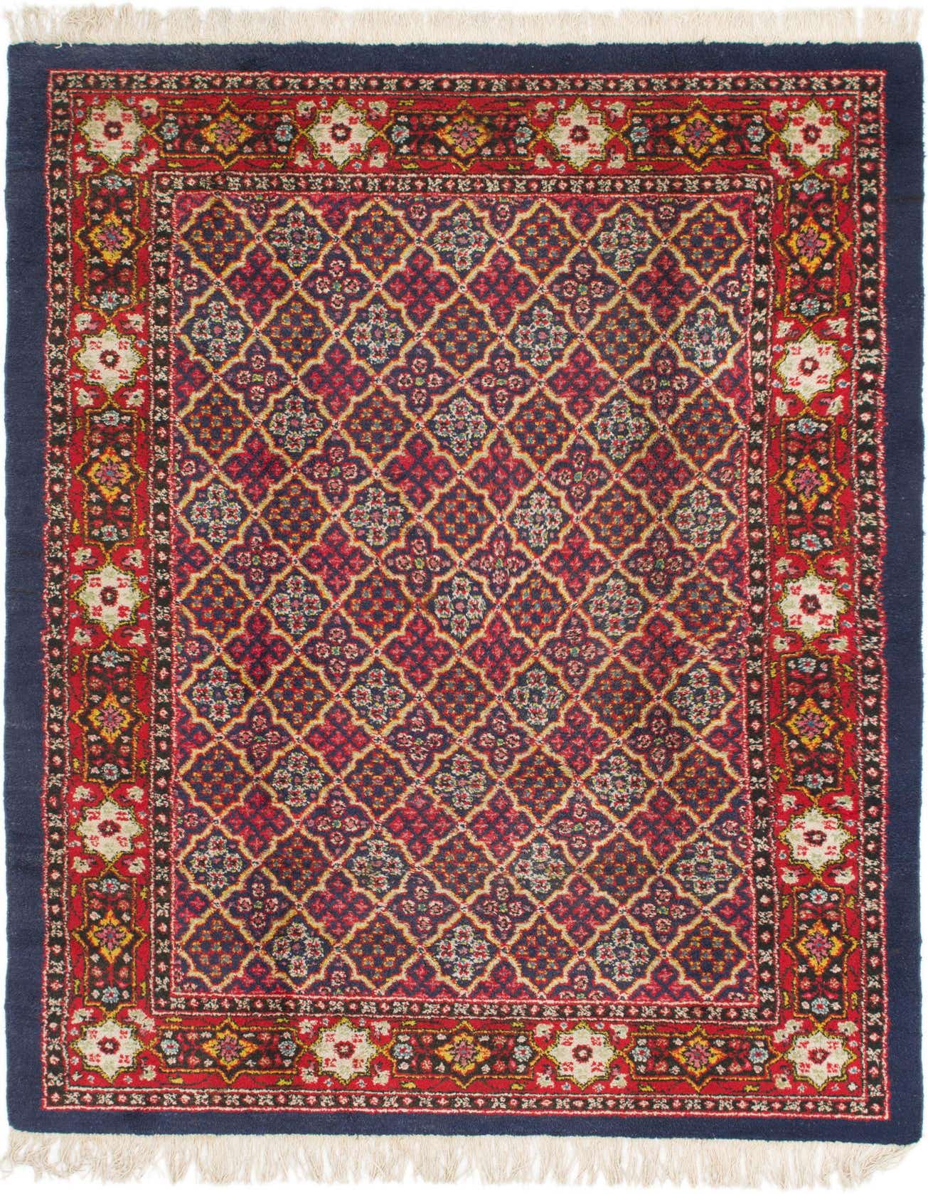 A 6x9 rectangular Kerman rug featuring a traditional pattern with a navy blue border and a red and multi-colored intricate floral medallion design.
