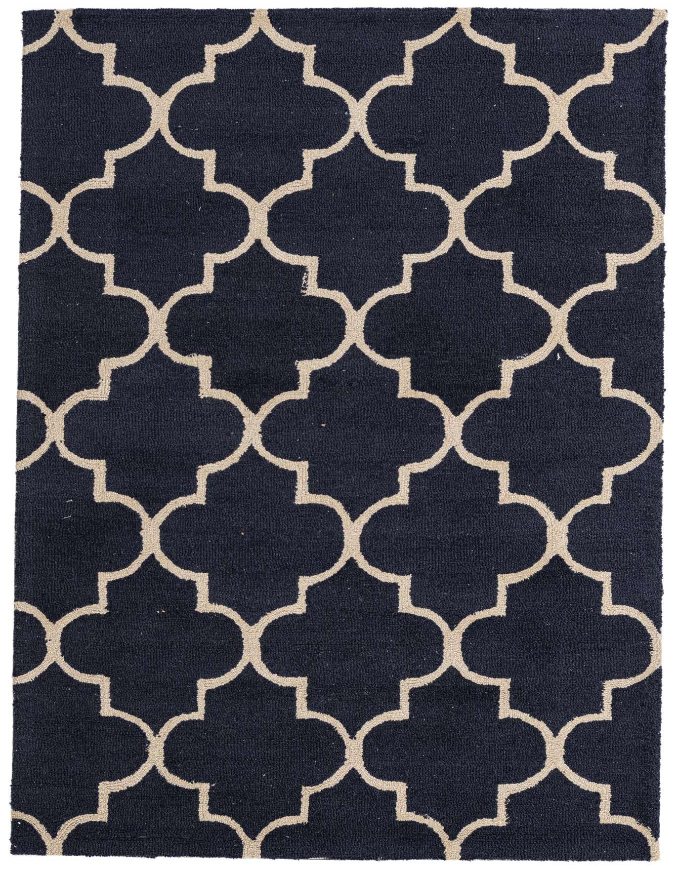 A 4x6 rectangular navy blue wool and cotton rug with a high pile and a modern abstract pattern of interlocking beige quatrefoils.