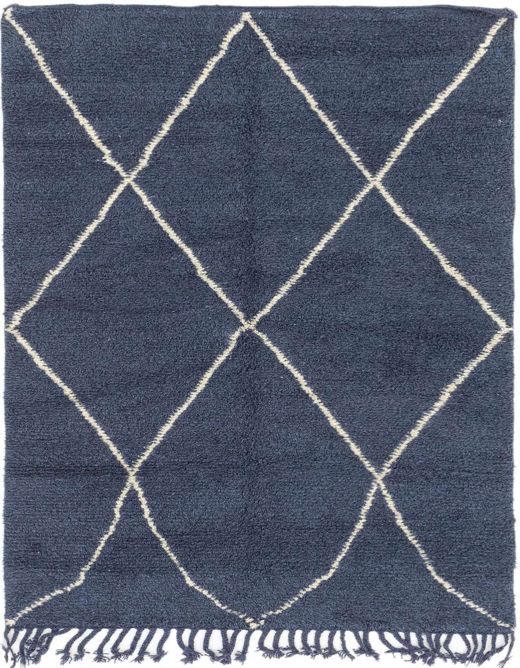 A 5x8 rectangular navy blue shag rug with a white tribal diamond pattern and fringe, suitable for a living room.