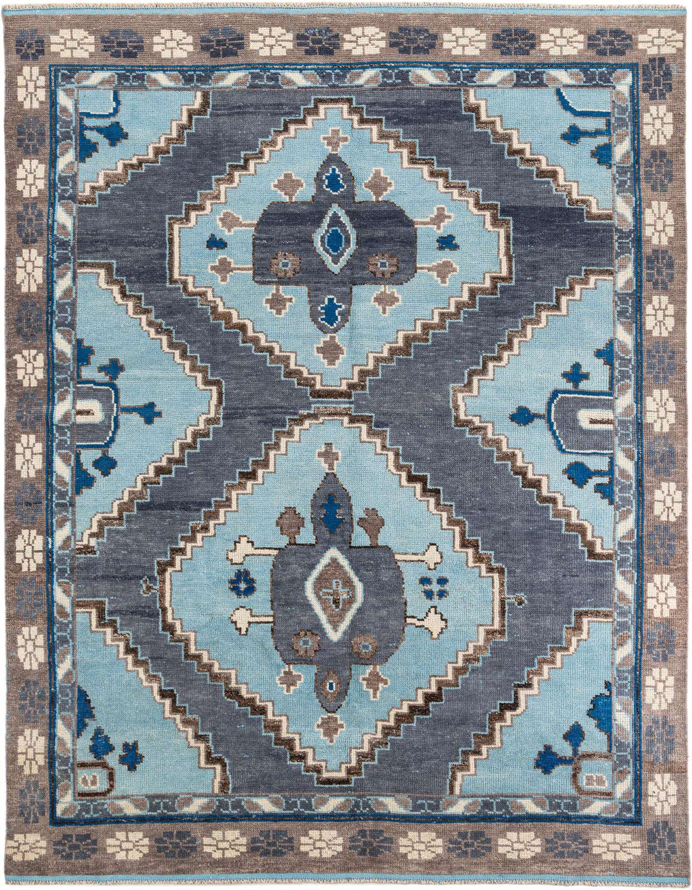 A 9x12 rectangular Moroccan shag rug with a tribal medallion pattern in varying shades of blue, brown, and cream.