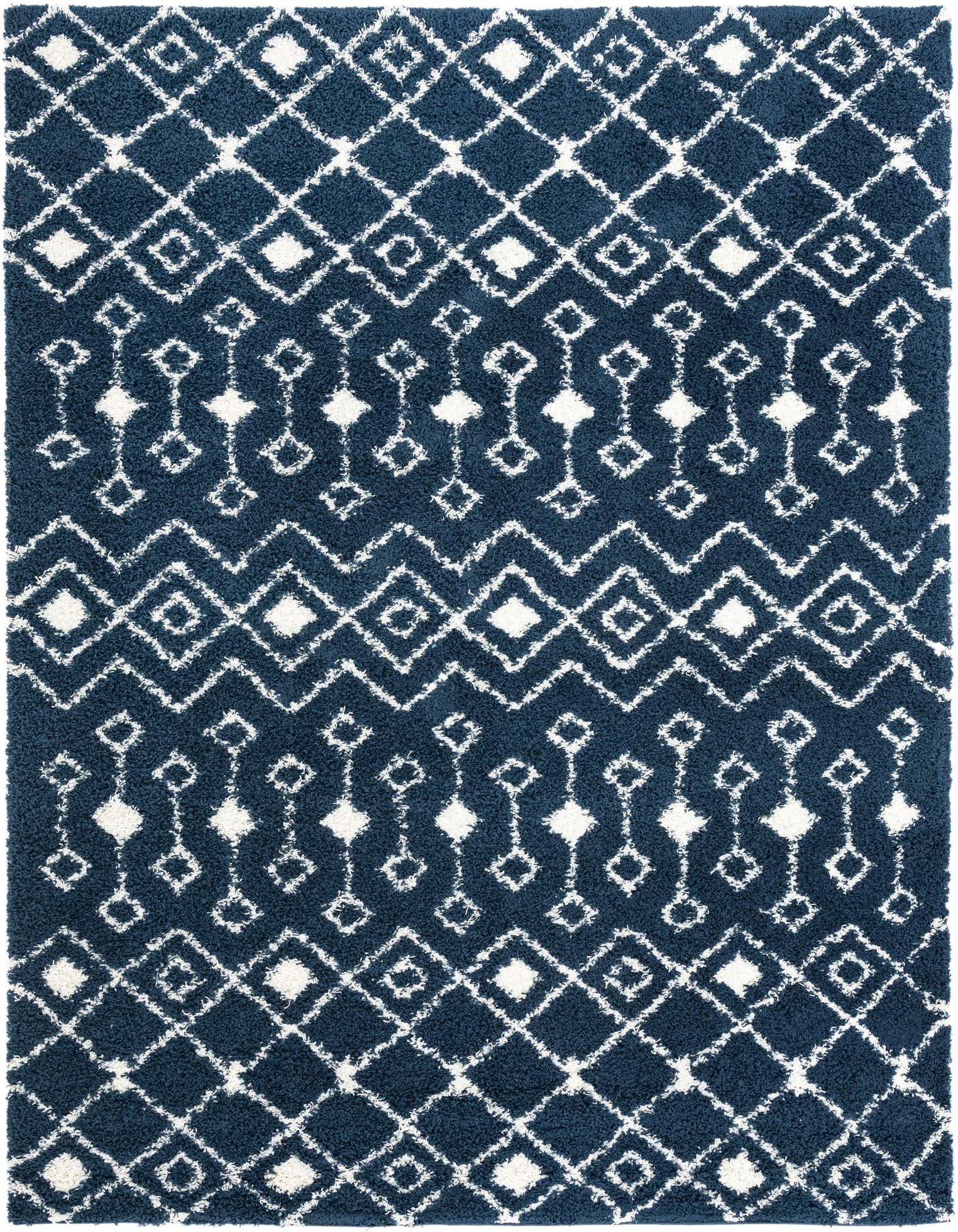 A 10x13 rectangular navy blue shag rug with a white modern tribal geometric pattern, perfect for a living room.