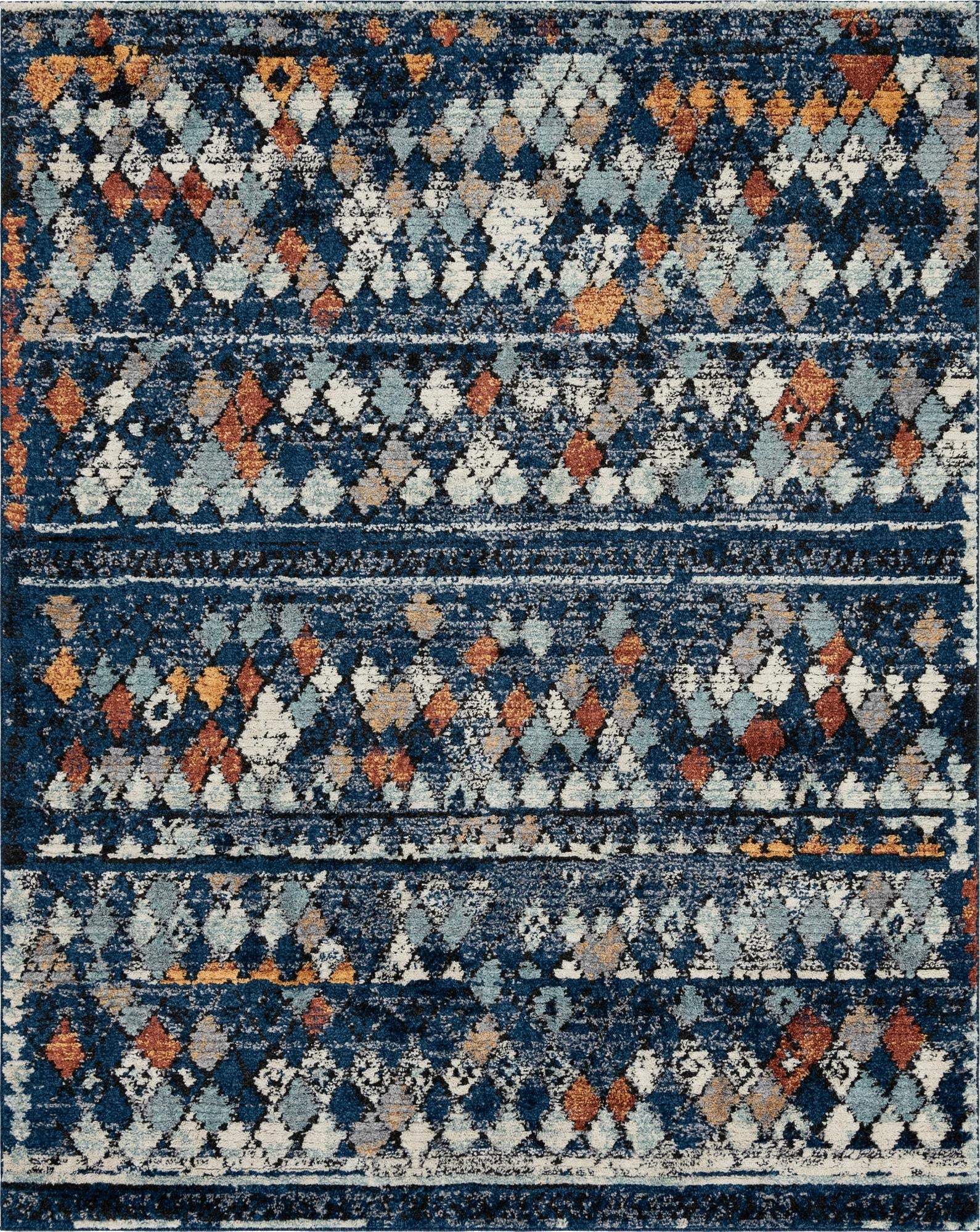 A rectangular 8x10 navy blue shag rug with a distressed modern tribal pattern in white, light blue, and orange diamond shapes.