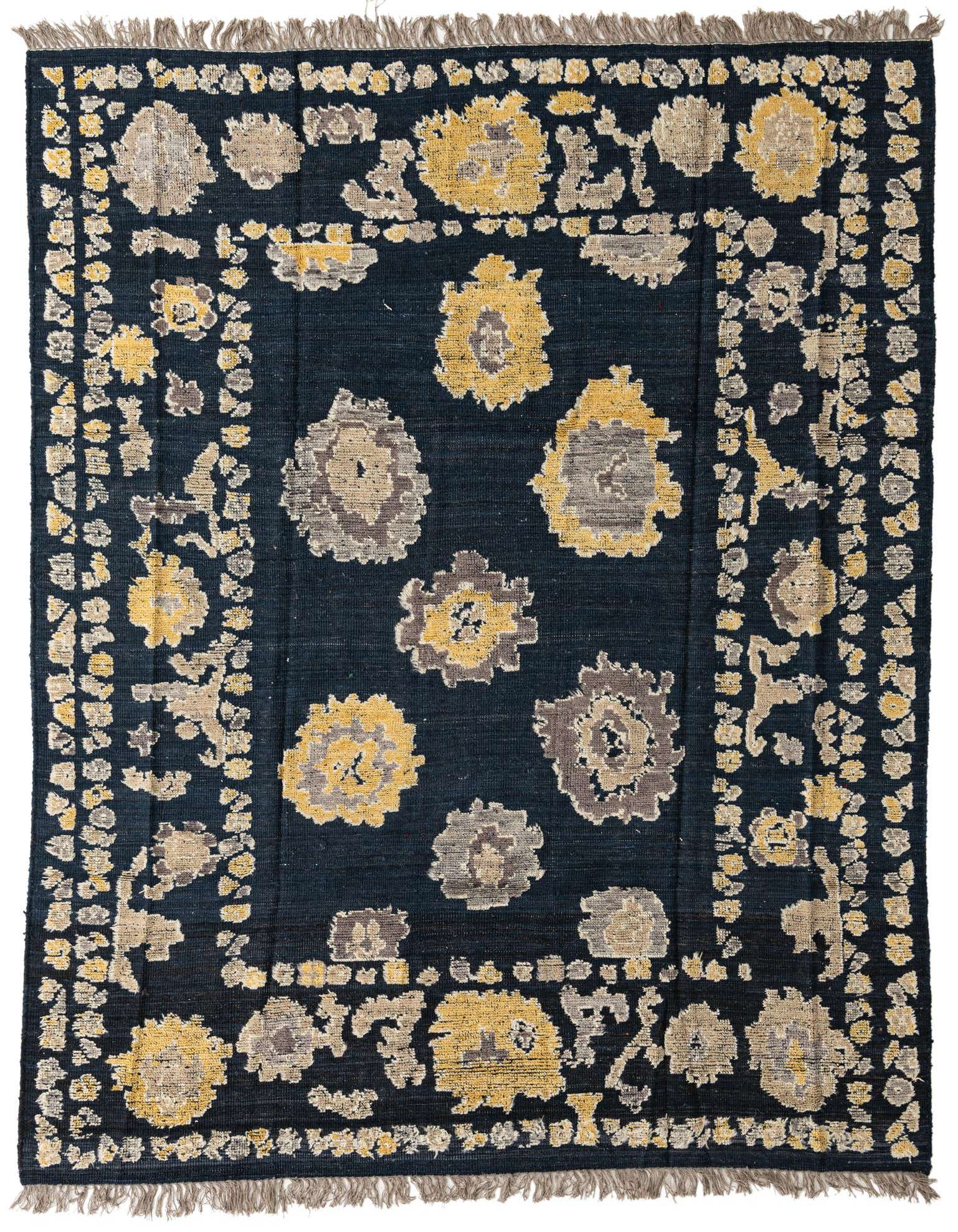 A rectangular 8x10 navy blue wool rug with a modern abstract pattern of yellow and grey floral shapes, featuring fringed edges.