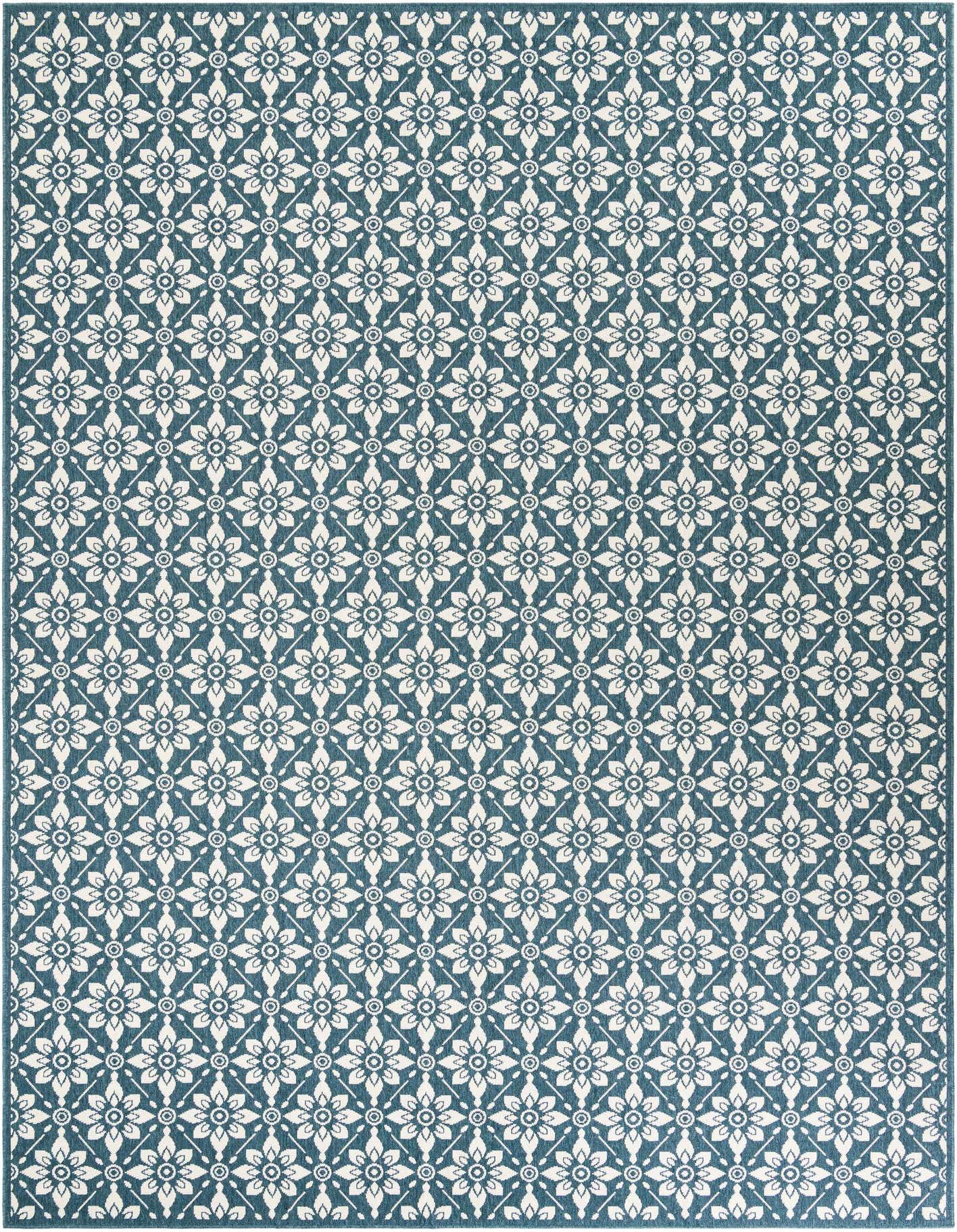 A 10x14 rectangular Rugs.com Outdoor Lattice rug featuring a repeating white floral and geometric pattern on a deep blue background.