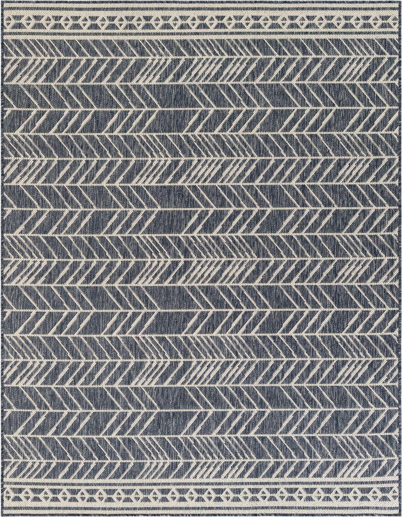 A 5x8 rectangular indoor/outdoor rug featuring a modern abstract pattern of off-white arrow-like shapes on a navy blue background, with decorative borders.