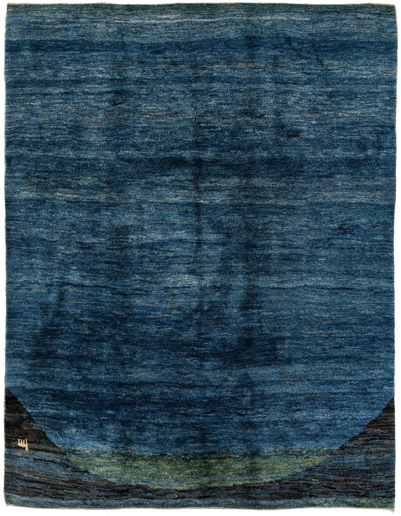 A rectangular 9x11 modern Persian rug featuring varying shades of blue, with abstract green and dark brown accents at the bottom.