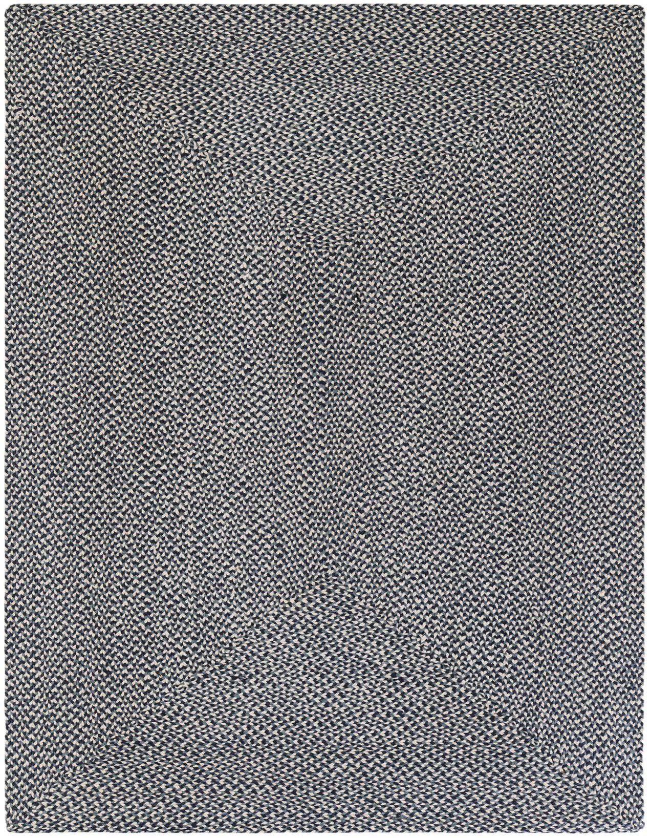 A 5x8 rectangular Rugs.com Tweed Braided Jute rug in varying shades of blue, showcasing its textured, handmade weave.