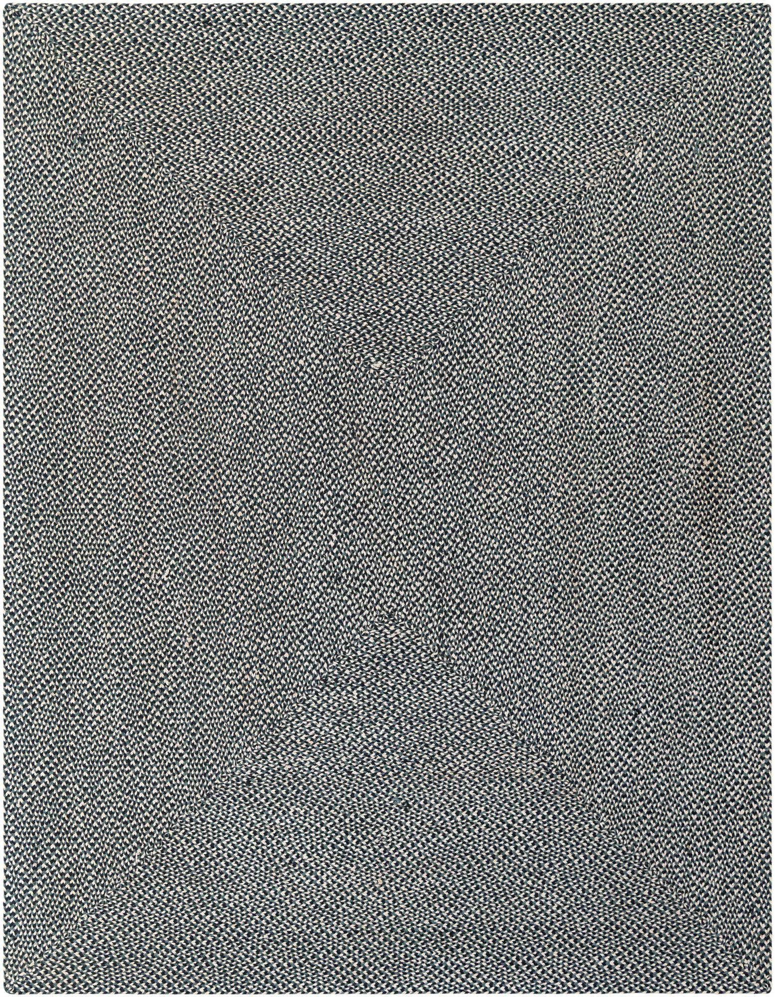 A close-up view of an 8x10 rectangular Rugs.com Tweed Braided Jute rug in varying shades of blue, showcasing its textured, handmade weave.