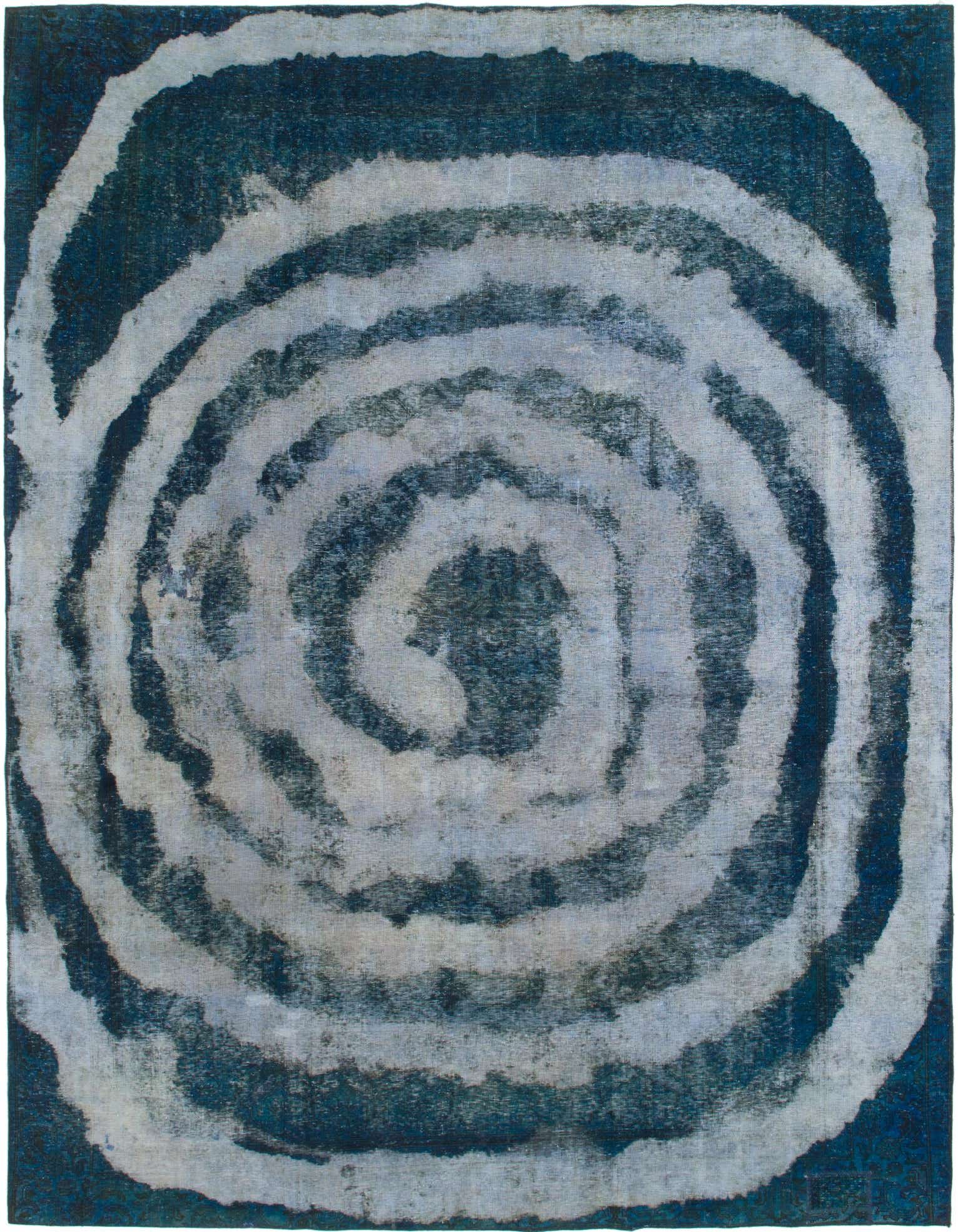 A 9x12 rectangular Ultra Vintage rug featuring an abstract, faded concentric spiral pattern in varying shades of blue and off-white.