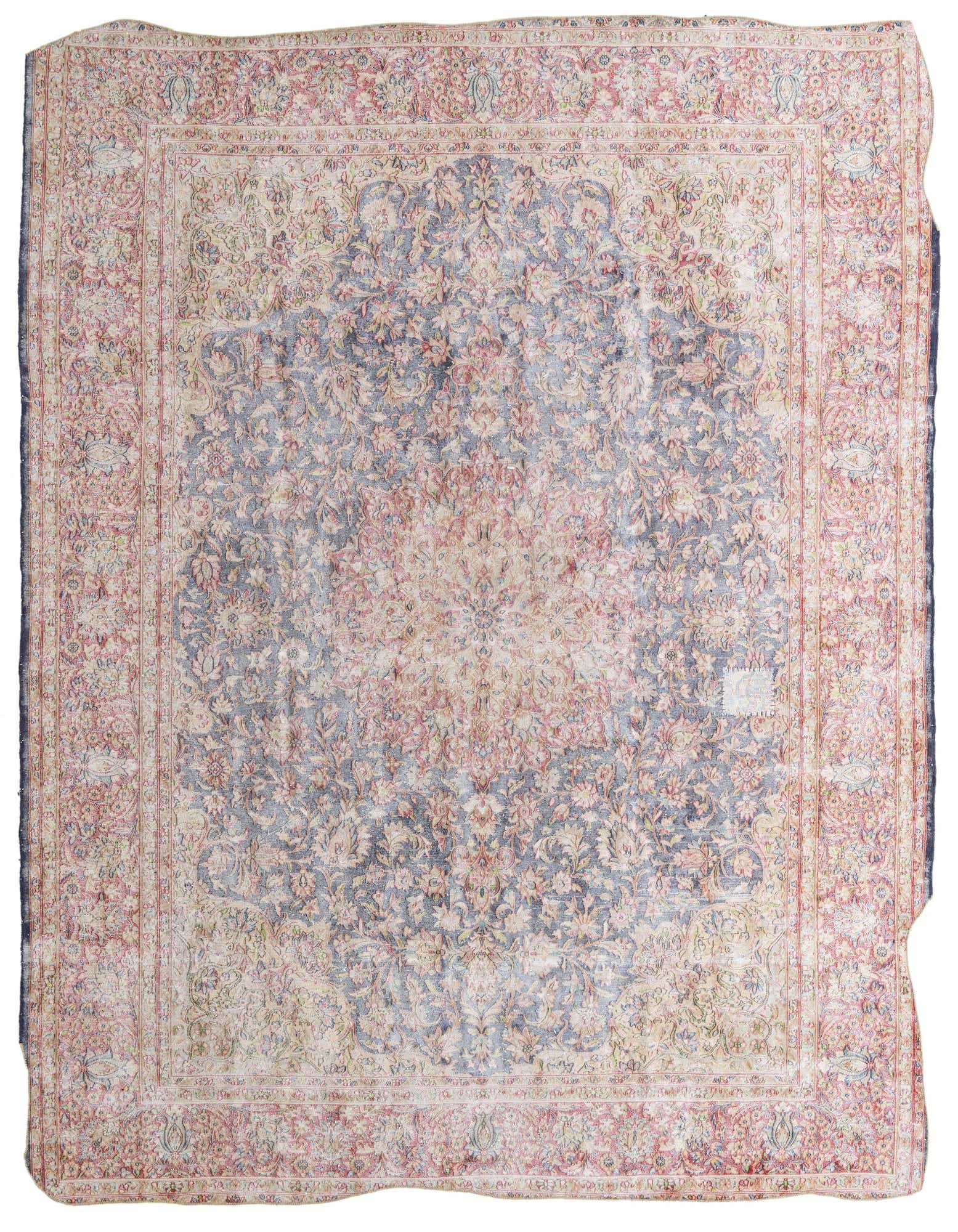 A 10x13 rectangular Ultra Vintage rug with a faded blue medallion center and intricate floral patterns in soft pinks and creams.