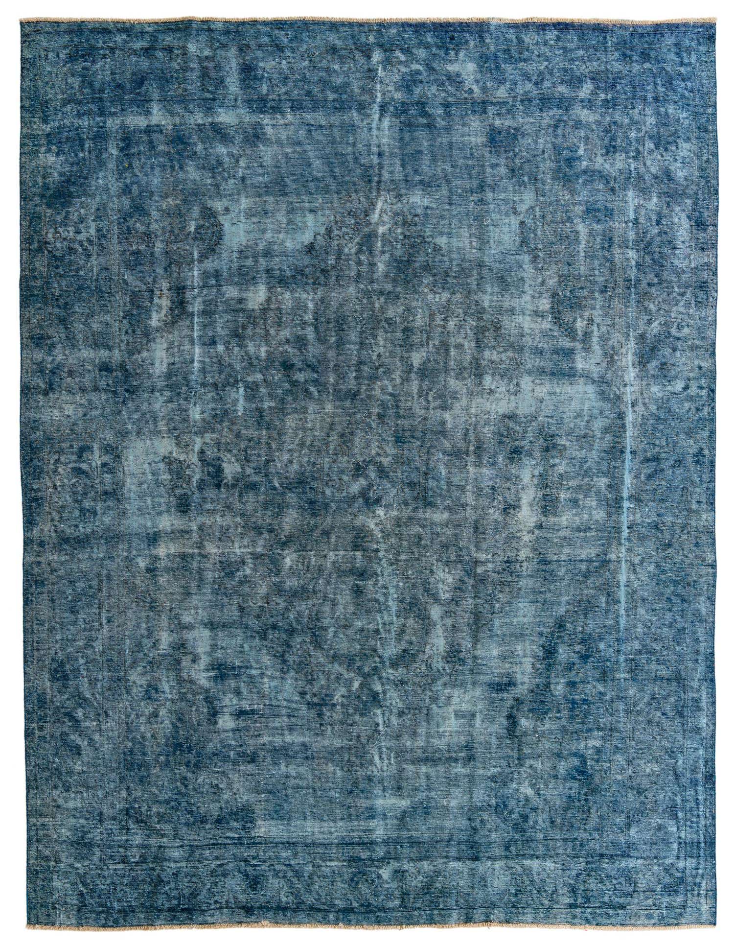 A large 10x13 rectangular indoor rug with a distressed Persian medallion pattern in varying shades of blue.