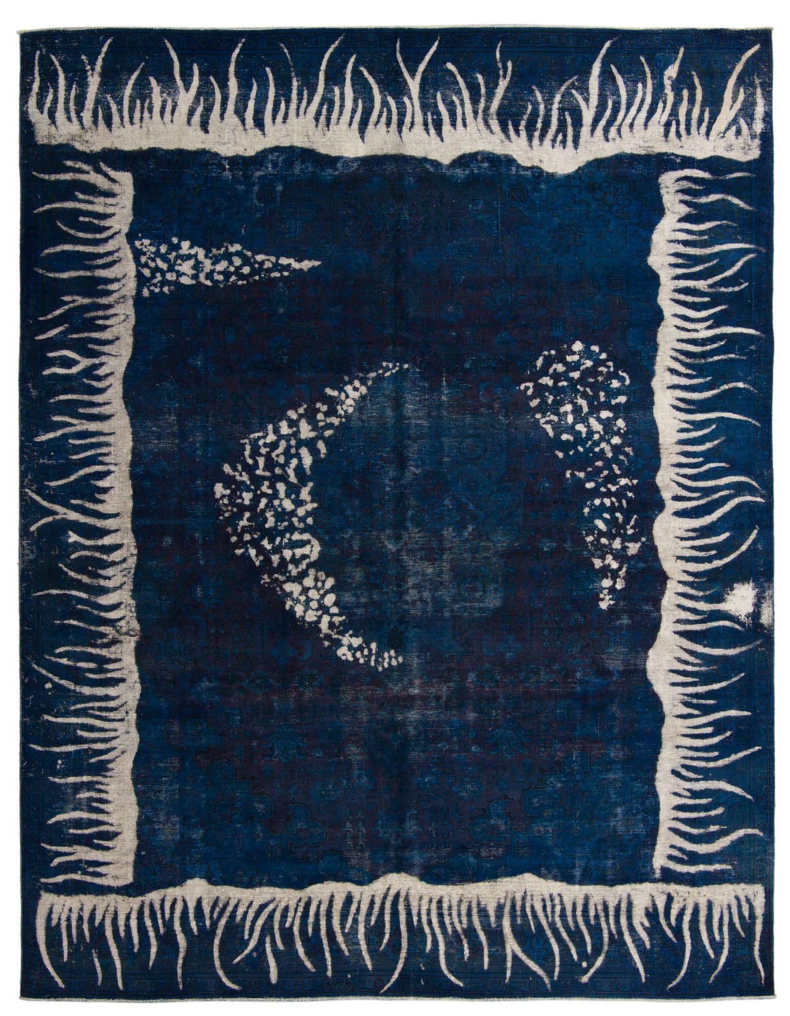 A 10x12 rectangular Ultra Vintage wool rug in deep navy blue with a distressed white border and abstract white shapes resembling a crescent and stars.