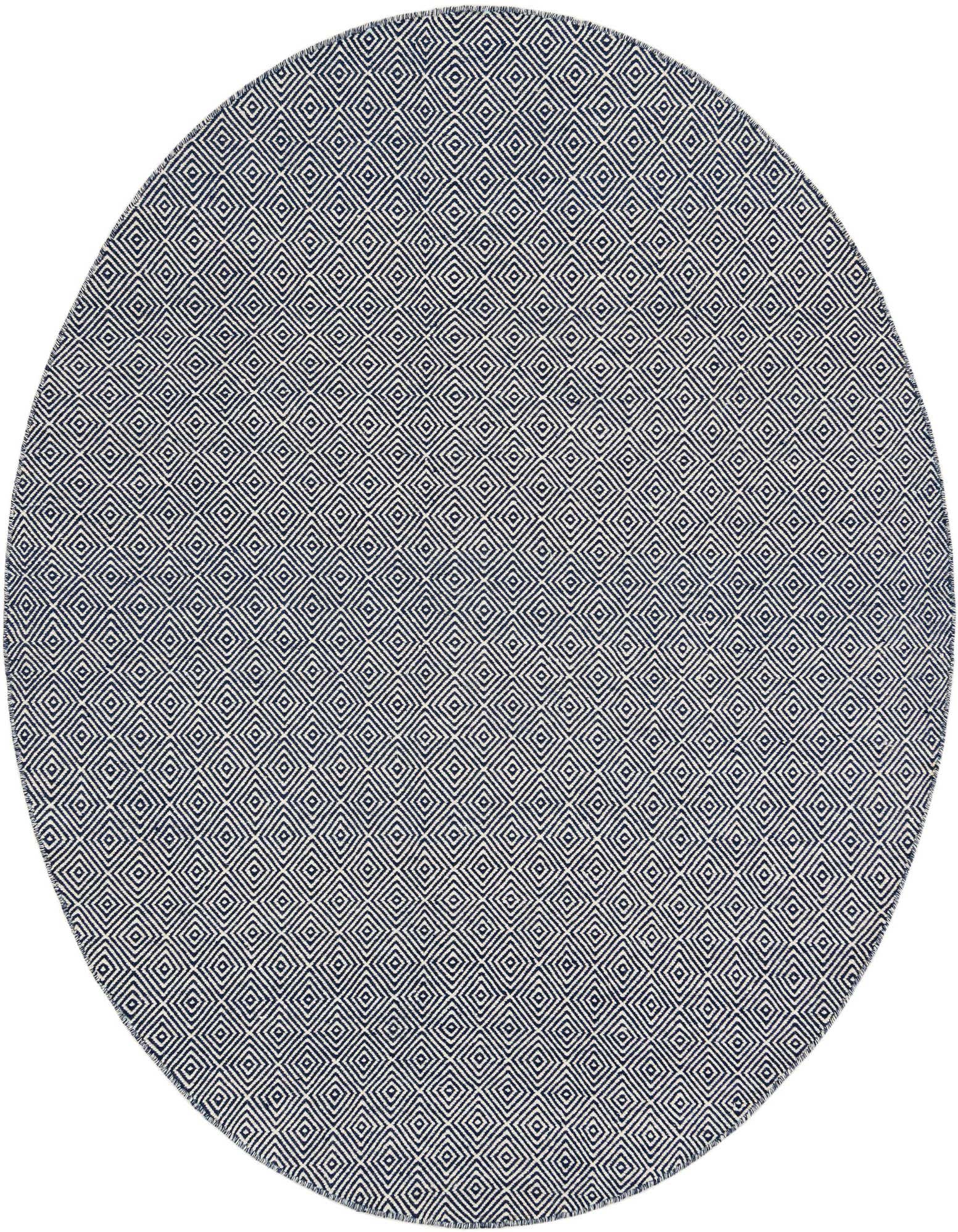 A round, navy blue and white flatweave rug with a modern geometric trellis pattern, made from wool and cotton.