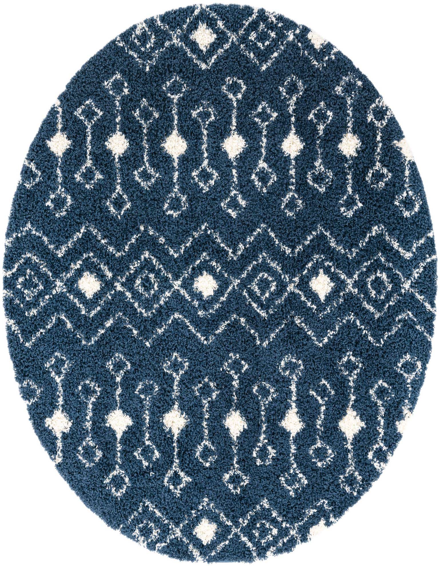 A round navy blue shag rug with a white tribal geometric pattern, featuring diamonds and zigzags.