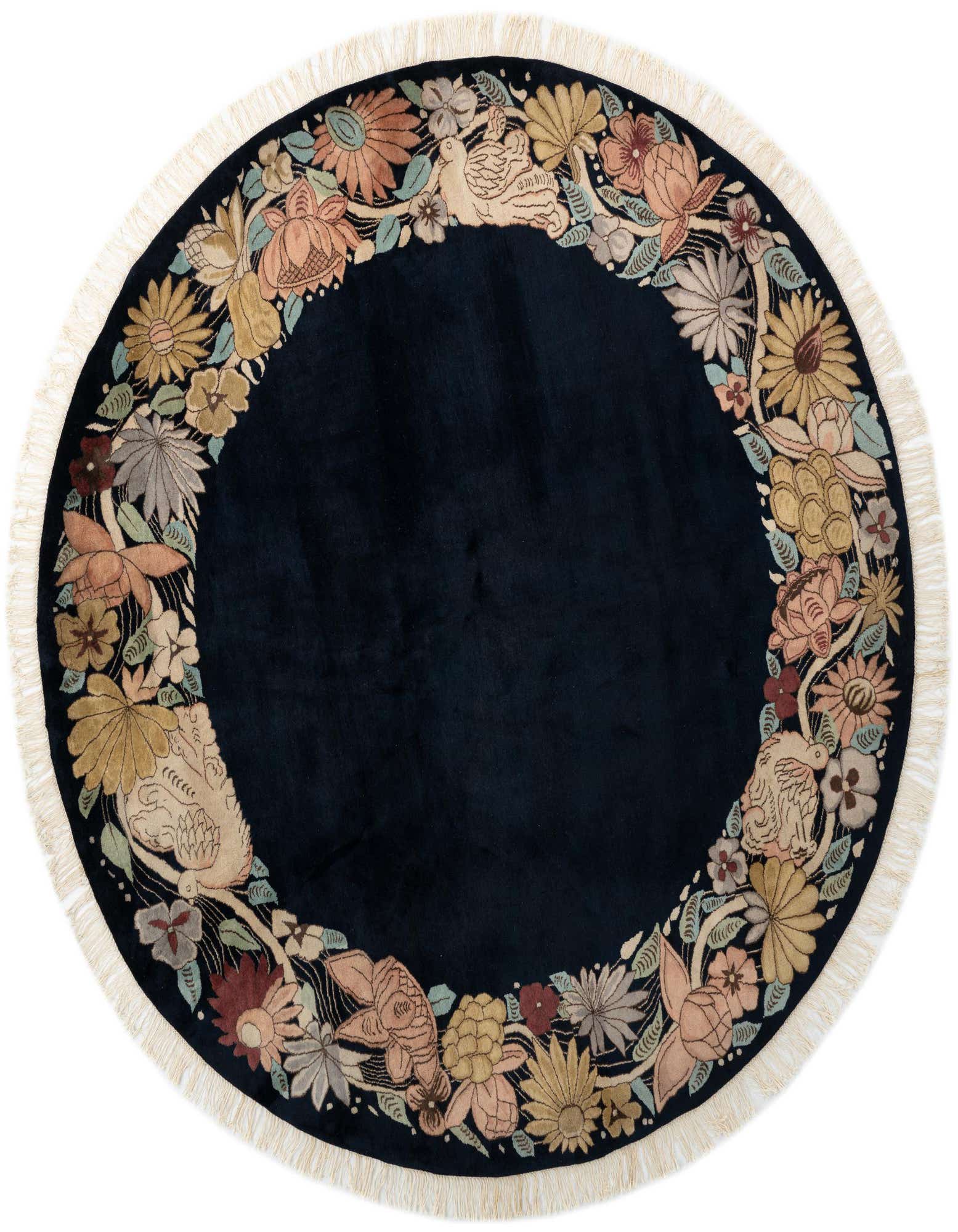 A round 8' 9 x 8' 9 navy blue wool rug featuring a border of colorful floral and bird motifs with fringe.