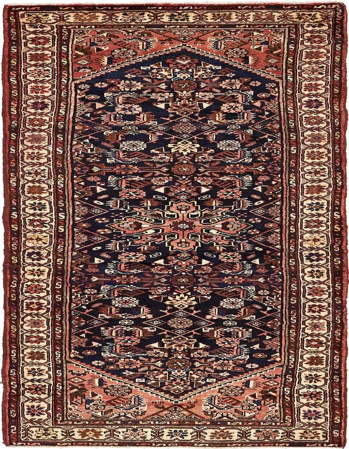 A 10 ft runner rug with a navy blue field and intricate botanical and tribal patterns in shades of red, cream, and brown.