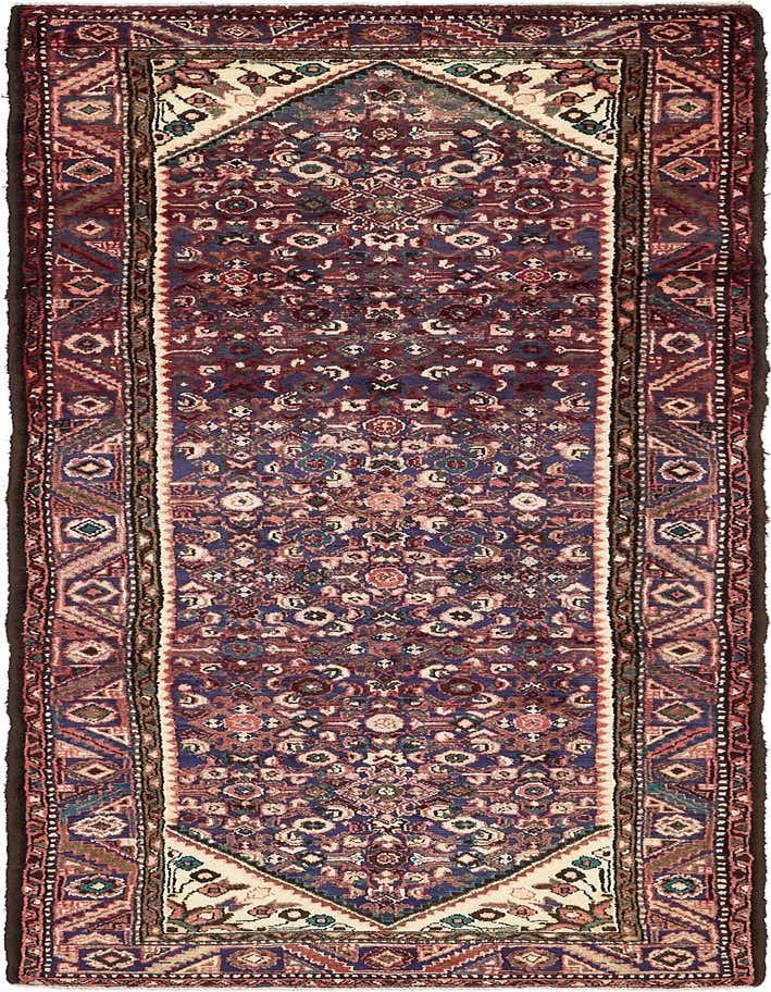 A 10 ft runner rug in a traditional Persian tribal style, featuring intricate patterns in shades of blue, red, and cream.