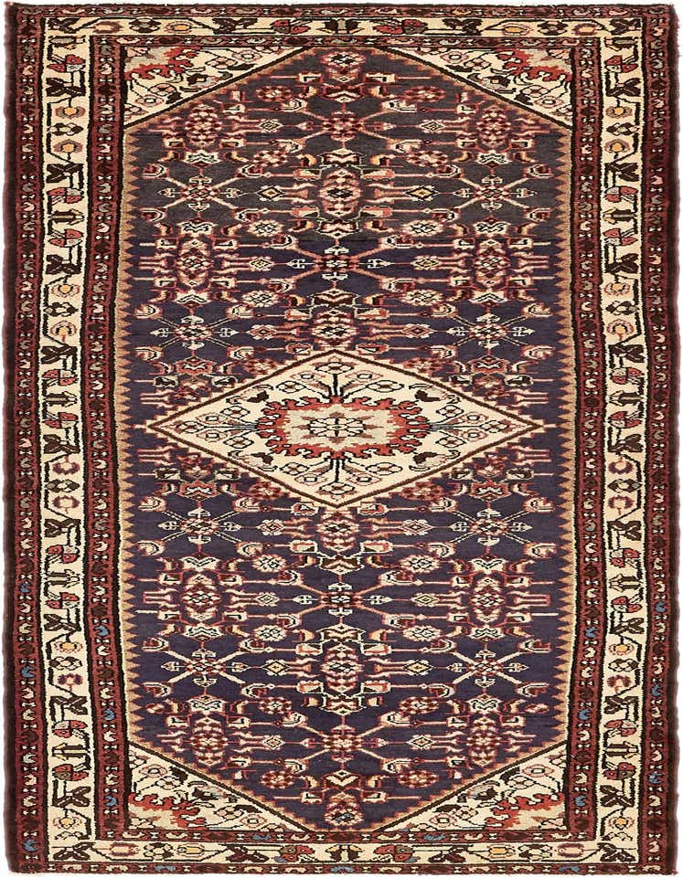 A 10 Ft Hossainabad runner rug featuring a tribal medallion pattern in navy blue, cream, and red.