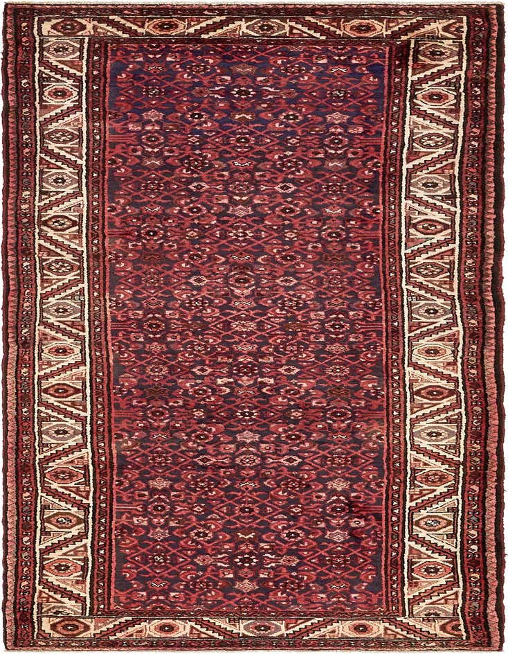 A handmade 11 ft runner rug in navy blue and red with a traditional Persian botanical and tribal pattern, ideal for a hallway.