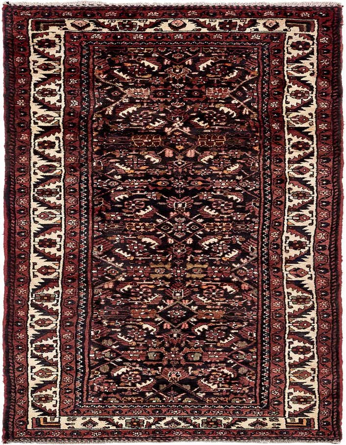 A 10 Ft runner rug in a traditional Persian tribal pattern, featuring deep blues, reds, and cream accents.