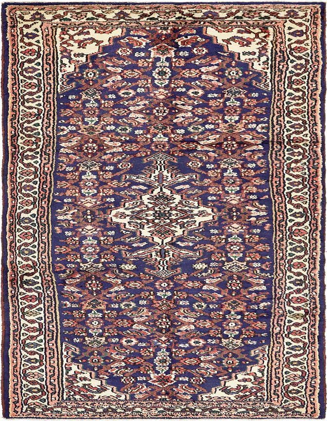 A 10 ft runner rug in a traditional Persian tribal pattern, featuring a navy blue field with a central medallion and intricate floral motifs in red, cream, and green, perfect for a hallway.