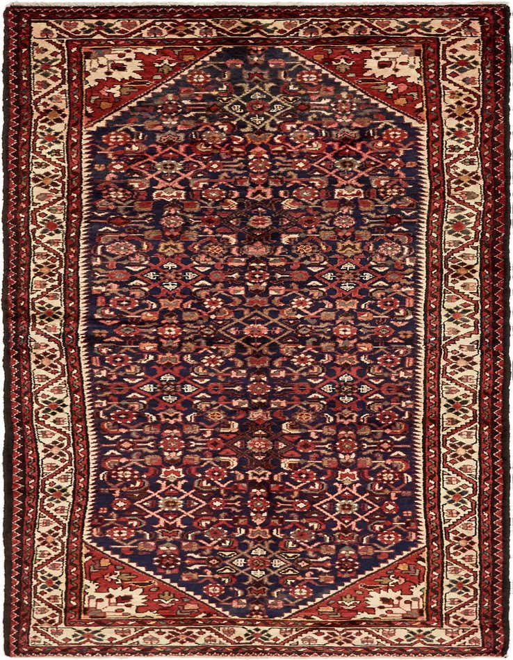 A handmade 10 Ft runner rug in a traditional Persian tribal pattern with a navy blue field and red and cream accents.